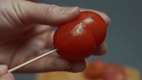 Smoke transformation effect of Uniting two halves of cherry tomatoes with a wooden skewer and placing it on a plate with fried egg for breakfast. 4K video. Artistic shooting