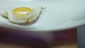 Smoke transformation effect of Fried chicken egg, shape in the form of a heart, put on a plate. Food for Valentine's Day. Concept of a funny surprise for a loved one for a special ocasion. 4K video