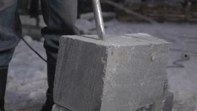 Cement split. Clip. A man in a uniform working with special equipment in winter.