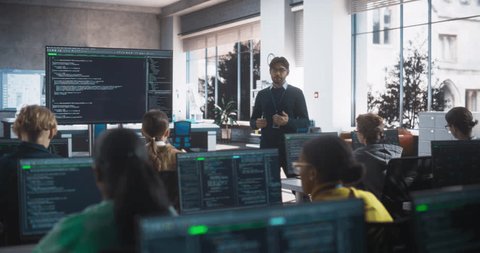 Knowledgeable Teacher Giving a Lecture About Software Engineering to a Group of Smart Diverse University Students. International Undergraduates Sitting Behind Desks with Computers स्टॉक व्हिडिओ