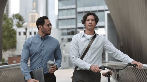 Two Confident Business People Walking Downtown, Talking and Spending Time Together Outside. Business Partners Going to Workplaces and Discussing Work Issues – Stockvideo