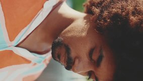 VERTICAL VIDEO, Close-up portrait of young man wearing shirt looking at the camera and smiling. Lifestyle concept. Slow motion