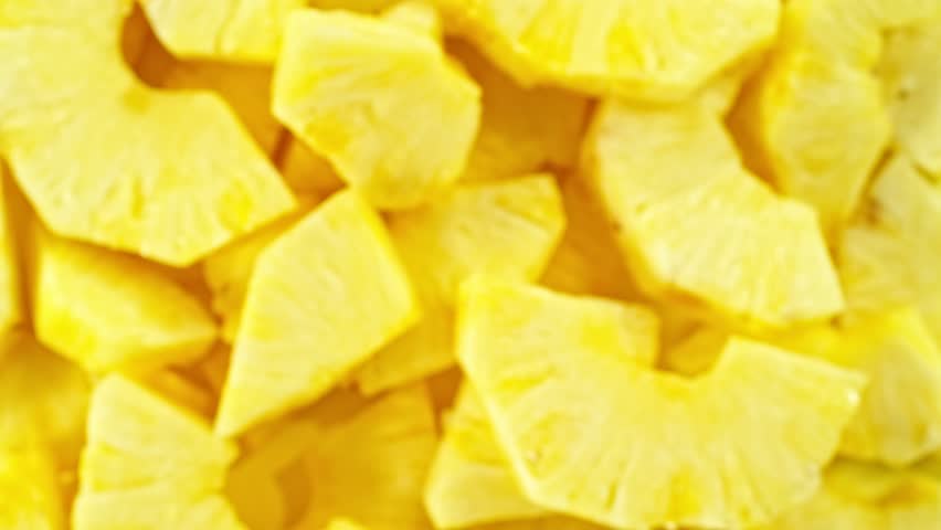 Super slow motion of rotating pineapple slices, top view. Filmed on high speed cinema camera, 1000 fps, placed on high speed cine bot, following the target.