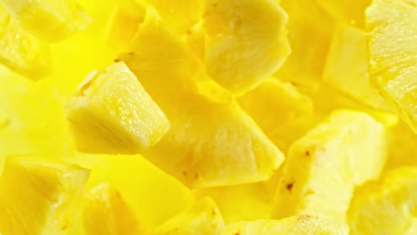 Super slow motion of rotating pineapple slices, top view. Filmed on high speed cinema camera, 1000 fps, placed on high speed cine bot, following the target.