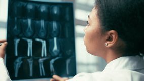 Female doctor examining patient's x-ray image, bone treatment, orthopedics - Powered by Shutterstock - Get 15% off with code: PIKWIZARD15