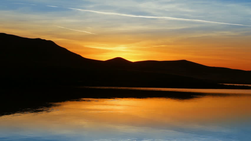sunrise on morning lake with mountain