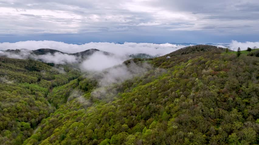 clouds and fog hang over holler near boone nc and blowing rock north carolina Royalty-Free Stock Footage #1103140841