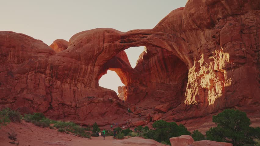Tourist hiking towards Double Arch in Arches National Park