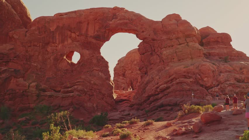 Tourist hiking towards Turret Arch in Arches National Park