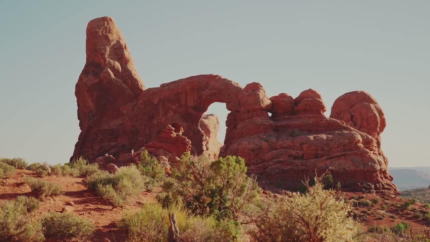 Tourist Walking in front of Turret Arch in Arches National Park