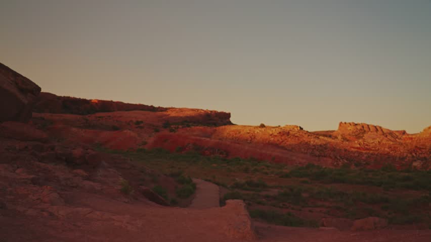 Tourist hiking in Arches National Park towards Delicate Arch