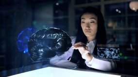 Asian woman Scientist work on 3D Simulated holographic Neural Brain Interface. Engineer using Augmented Holographic Technology. Artificial Intelligence Concept - Powered by Shutterstock - Get 15% off with code: PIKWIZARD15