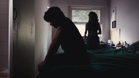 Silhouette of Couple Fighting in Bedroom, with Husband Distressed and Suffering from Bad Relationship While Wife Argues with Him - Powered by Shutterstock - Get 15% off with code: PIKWIZARD15
