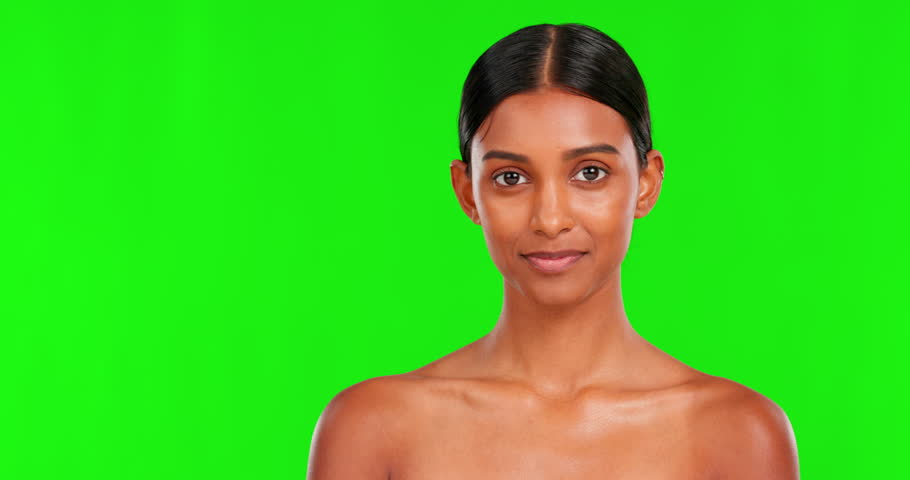 Skincare, smile and a woman pointing on a green screen background in studio for natural beauty. Portrait, space and antiaging treatment with a happy young female model advertising on chromakey mockup Royalty-Free Stock Footage #1103150821