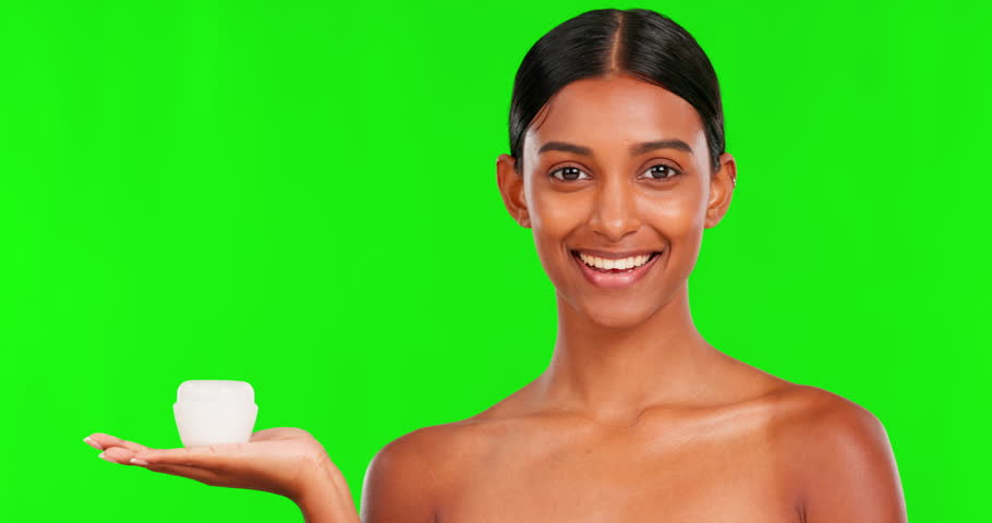 Skincare, lotion and a woman pointing on a green screen background in studio for natural beauty. Portrait, product or antiaging treatment with a happy young female model marketing on chromakey mockup Royalty-Free Stock Footage #1103150939