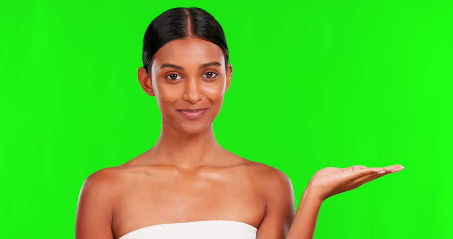 Skincare, product and a woman pointing on a green screen background in studio for natural treatment. Portrait, beauty and antiaging with a happy young female model advertising on chromakey mockup Royalty-Free Stock Footage #1103150967