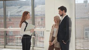 Real estate agent hands over the keys to a young couple after purchasing or renting a property for their cafe or business. Man and woman hug each other in excitement, pleased with the investment. - Powered by Shutterstock - Get 15% off with code: PIKWIZARD15