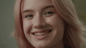 Woman with Dental Braces Smiling Portrait. Pretty 20s female looking at camera.  - Powered by Shutterstock - Get 15% off with code: PIKWIZARD15