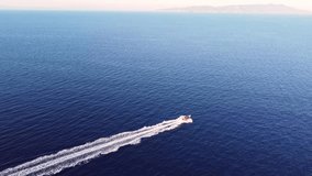 AERIAL: Speed boat fast movement on dark blue water, side view of the boat 4k video.
