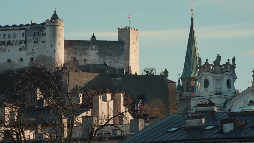 River gulls fly in front the famous Hohensalzburg Fortress in Salzburg, Austria