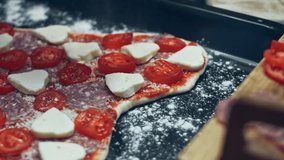 Smoke transformation effect of Seasoning pizza with basil on the baking tray. Preparing heart shaped pizza for Valentine's Day for a loved one. 4K video