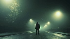 A spooky science fiction concept. A mysterious hooded figure, back to camera. Standing on an empty road. With glowing UFO lights floating in the sky. On a eerie winters foggy night - Powered by Shutterstock - Get 15% off with code: PIKWIZARD15
