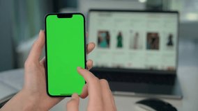 Close up of Phone With Green Mock-up Screen In Female Hands. Girl Uses Phone for Online Shopping