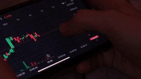 Investment stockbroker analysis data graph with price rates. Crypto trader investor broker holding using smartphone app analyzing financial data stock market on cell phone, checking online trading - Powered by Shutterstock - Get 15% off with code: PIKWIZARD15