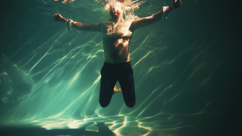 Winner joy emotional man screaming underwater. Guy businessman falls sinks to bottom sea fails failure in business work. Tired office worker Creative shooting in blue water pool anger fashion model 4k Royalty-Free Stock Footage #1103172581