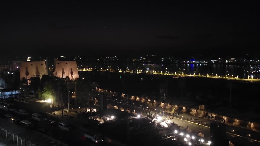 Luxor, Egypt: Nile embankment with boats and Luxor Temple in Luxor, beautiful night landscape, Egypt.