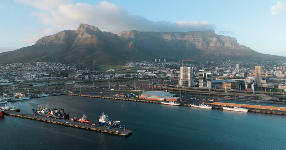 Spectacular aerial panning view of Cape Town Waterfront, Harbour, City Centre, Table Mountain, Lion's Head, Signal Hill, Cape Town,  South Africa Royalty-Free Stock Footage #1103177441