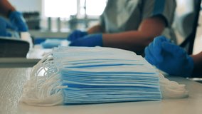 Medical masks are getting put into batches in a close up - Powered by Shutterstock - Get 15% off with code: PIKWIZARD15