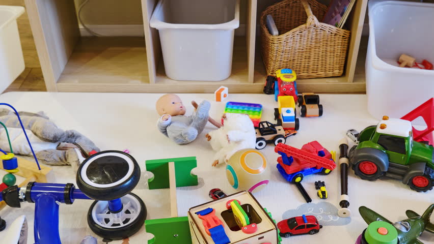 Children room littered with toys and a clean nurseryб stop motion. Mess due to toys scattered on the floor and things put away in a box, before and after cleaning Royalty-Free Stock Footage #1103181383