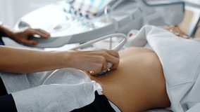 Doctor moving sensor of ultrasound machine by the female belly. Ultrasonic diagnostics on early stages of pregnancy. - Powered by Shutterstock - Get 15% off with code: PIKWIZARD15