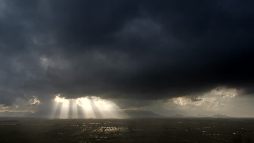 Time lapse video of black storm clouds over plains in flooded fields after the rain.