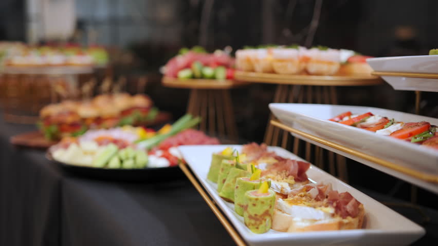 Mini burgers on a wooden tray, snacks on the table, catering concept. Move camera shot | Shutterstock HD Video #1103186977