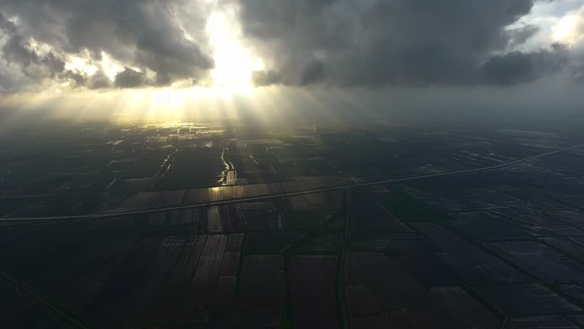 Aerial view of black storm clouds over plains in flooded fields after the rain.