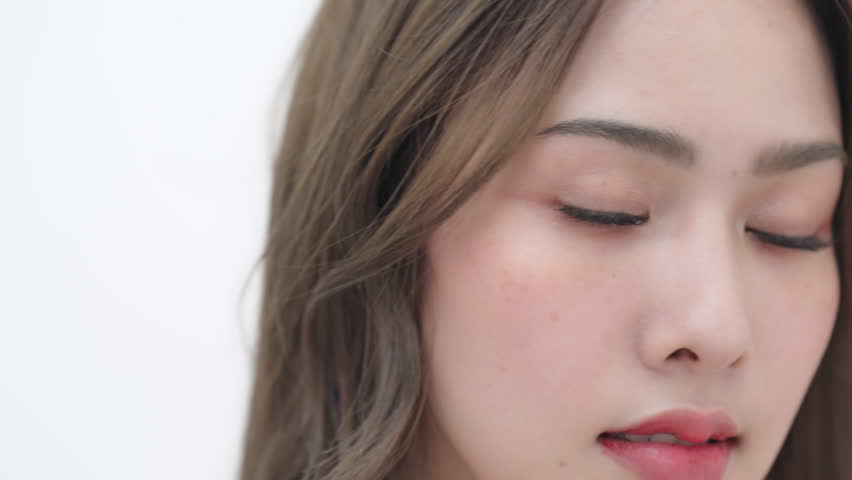 Asian beauty close up face point at eyelash extension smile look at camera Royalty-Free Stock Footage #1103195351