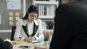 Office worker in secretary position taking notes during company meeting in meeting notebook - Powered by Shutterstock - Get 15% off with code: PIKWIZARD15