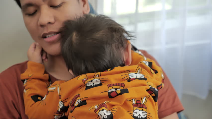 little boy playing with his father in the living room