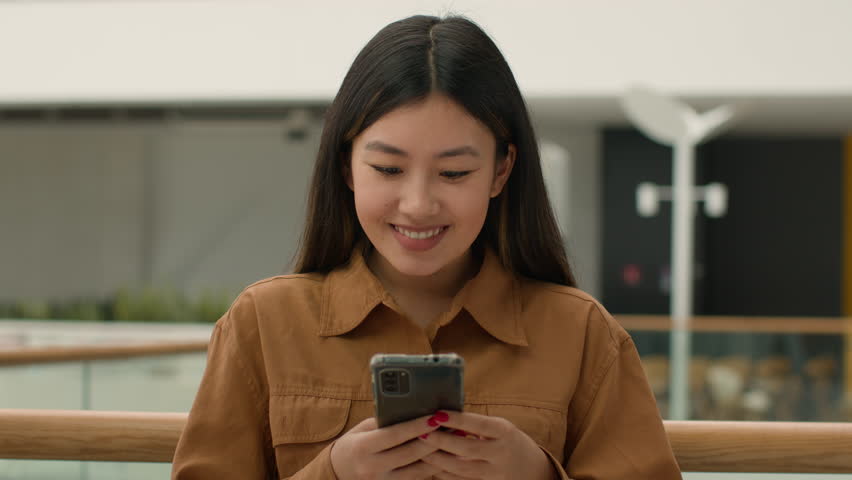 Shocked excited businesswoman client win online bet celebrate victory happy Asian korean japanese chinese woman girl with mobile phone rejoice winning prize make yes gesture business triumph success | Shutterstock HD Video #1103200303