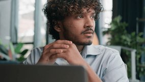 Thoughtful male guy Indian Arabian businessman office manager ceo entrepreneur employee work laptop doubtful latino man think decision solve problem thinking business project brainstorm deep thoughts - Powered by Shutterstock - Get 15% off with code: PIKWIZARD15