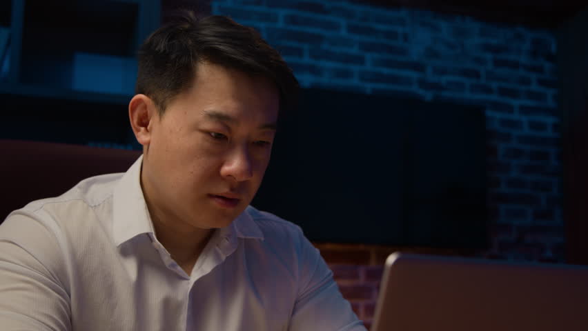 Exhausted middle-aged Asian man massaging dry irritable eyes tired overworked Korean businessman eye strain computer laptop working at night evening insomnia headache visual fatigue eyestrain pain Royalty-Free Stock Footage #1103200369