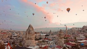 Panoramic view of Goreme, Turkey with hot-air balloons at sunrise. Goreme is known for its fairy chimneys, eroded rock formations