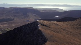 Spectacular 4K aerial video of flying above picturesque mountains close to the Atlantic coast with epic views around