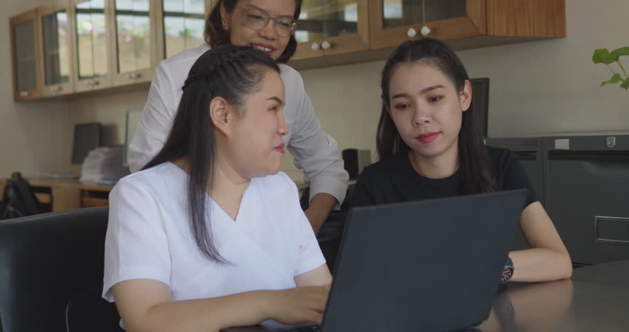 Asian women co-workers in workplace including person with blindness disability using laptop computer with screen reader program for visual impairment people. Disability inclusion at work concepts. Royalty-Free Stock Footage #1103212791