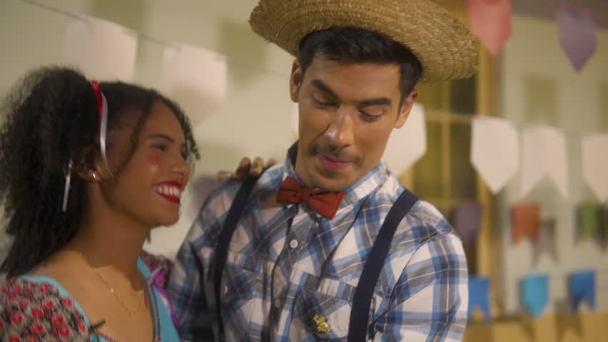 Festa Junina: party in Brazil, romantic couple dancing at arraial event in traditional clothes