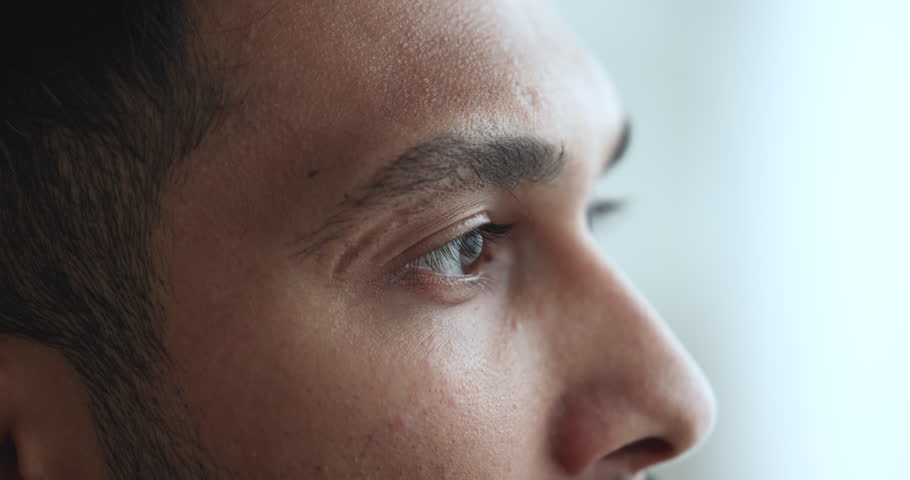 Young serious Indian man looking away, side profile cropped face view. Silent, pensive guy staring into distance, deep in thoughts. Extreme close up view male eye, lenses, laser vision correction ad Royalty-Free Stock Footage #1103218723