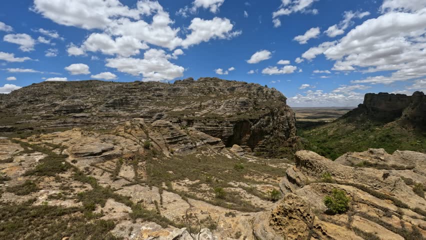 Isalo National Park. Panoramic view of wilderness landscape with water erosion into rocky outcrops, plateaus, extensive plains and deep canyons. Beautiful Madagascar panorama landscape with blue sky.