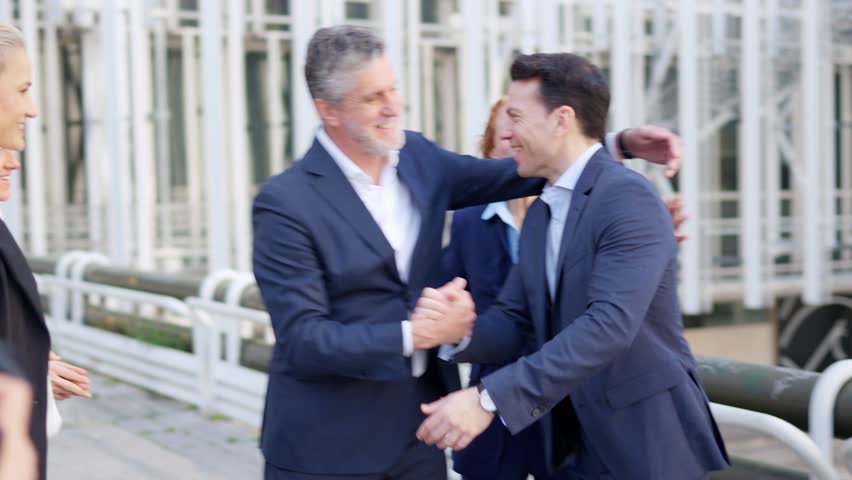 Mature businesswoman introducing a new employee to the company outdoors